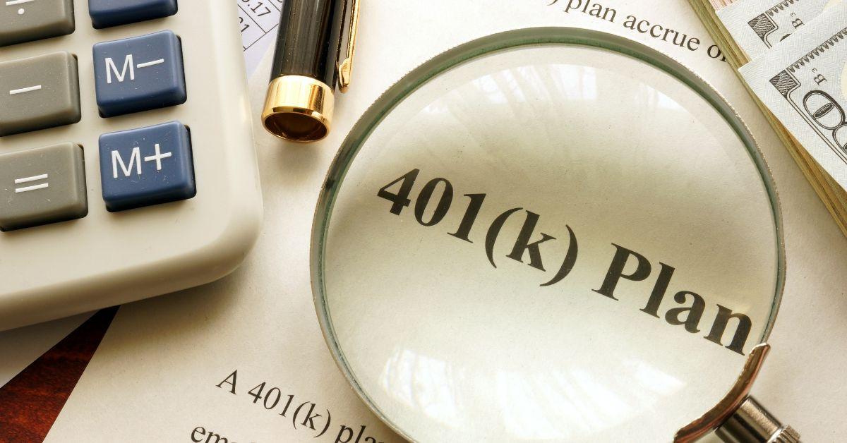 Paperwork and calculator showing off a 401(k)